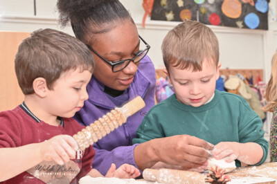 Staff member at Brentford with two boys during messy play session