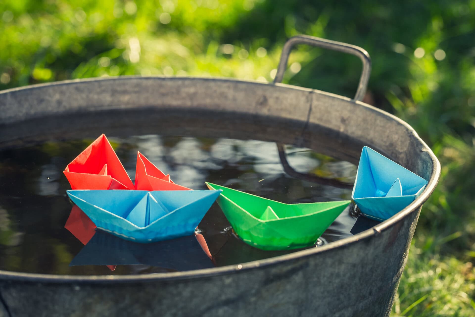 DIY paper boats floating in water; early years activities